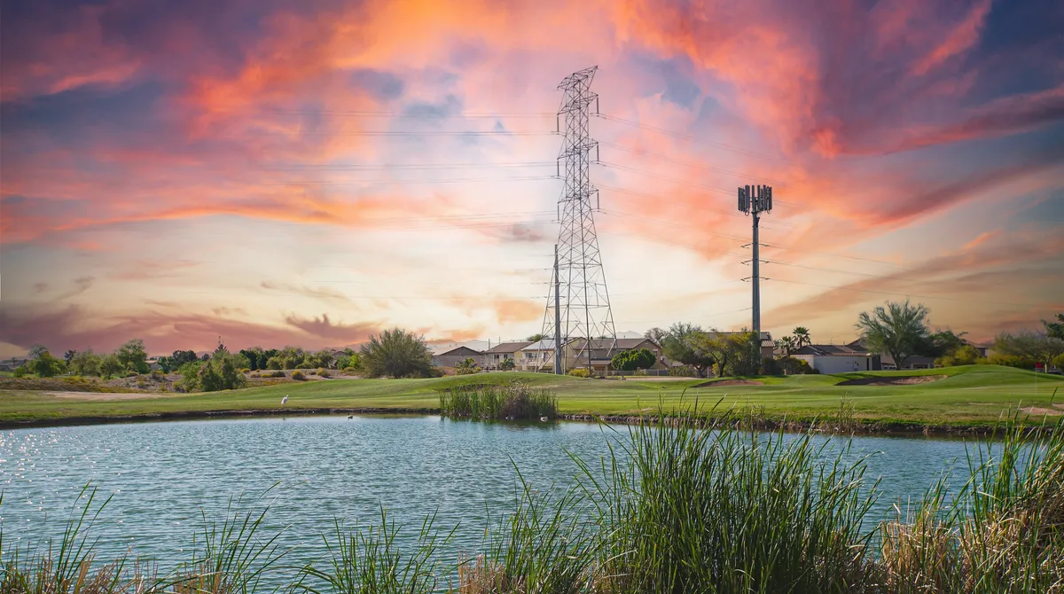 A tranquil, wide-angle view of the lake at sunset with grassy edges and open sky. The scene captures the natural setting, ideal for fishing, golfing, or simply watching the sunset, emphasizing the backyard's direct connection to nature and water.